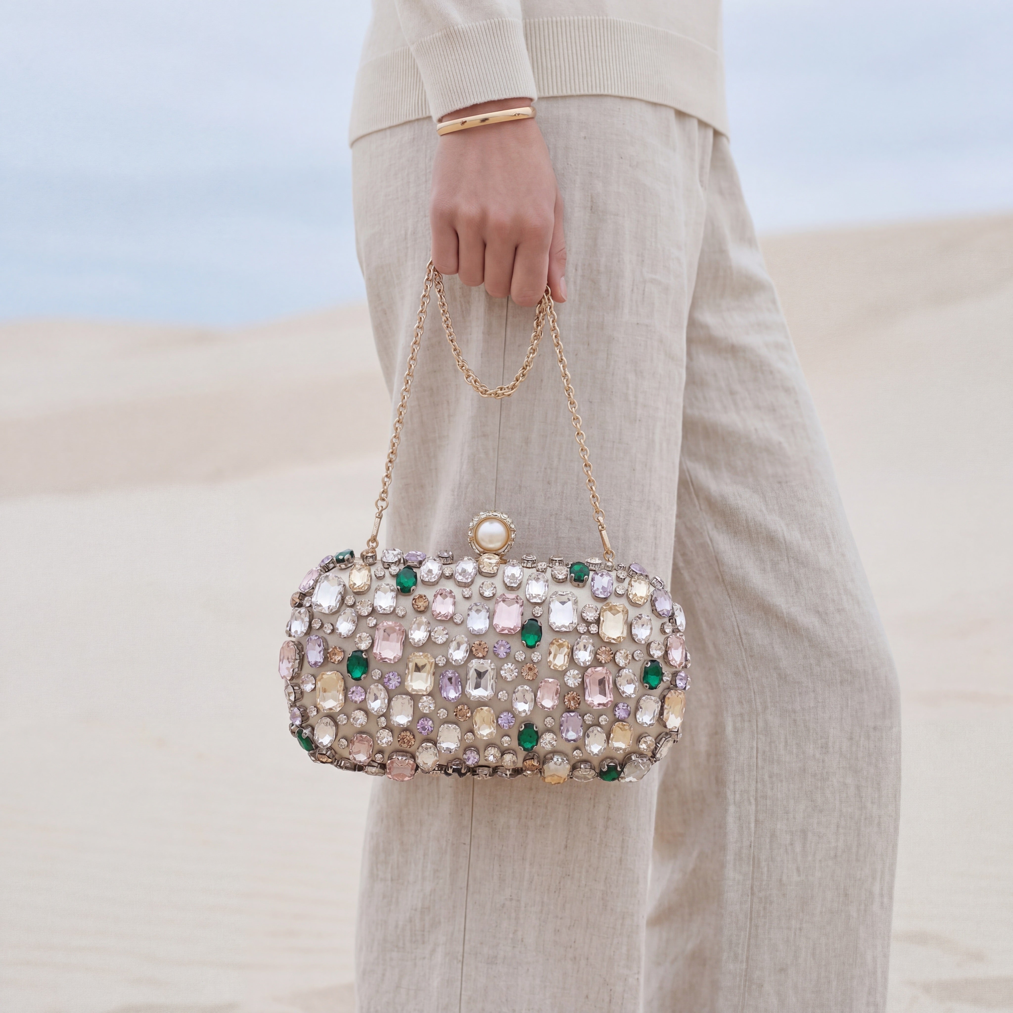 Person holding a sparkling handbag with a blurred background